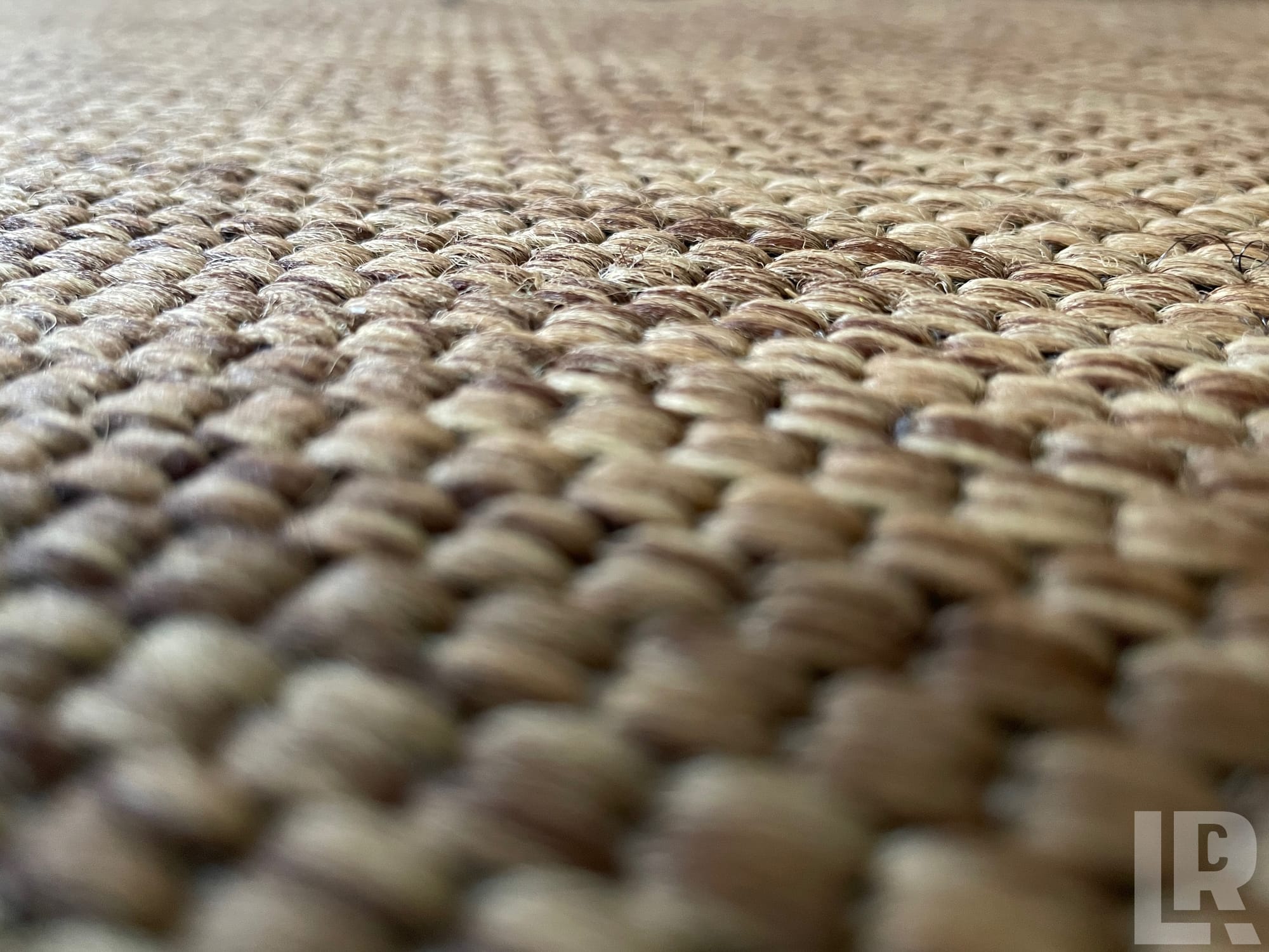 Close-up of a woven jute or seagrass rug showing its textured weave pattern