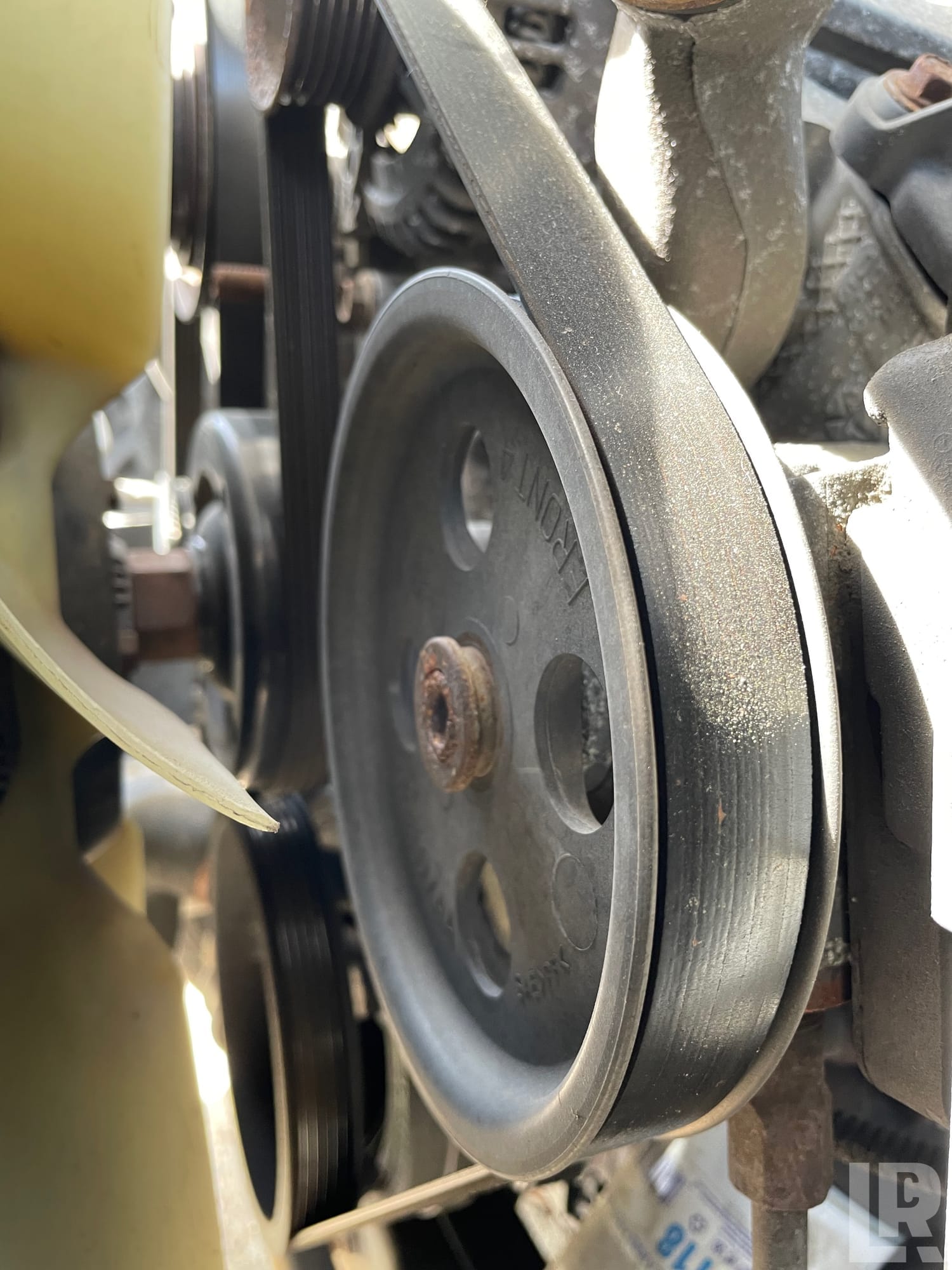 Close-up of a serpentine belt on an engine crankshaft pulley