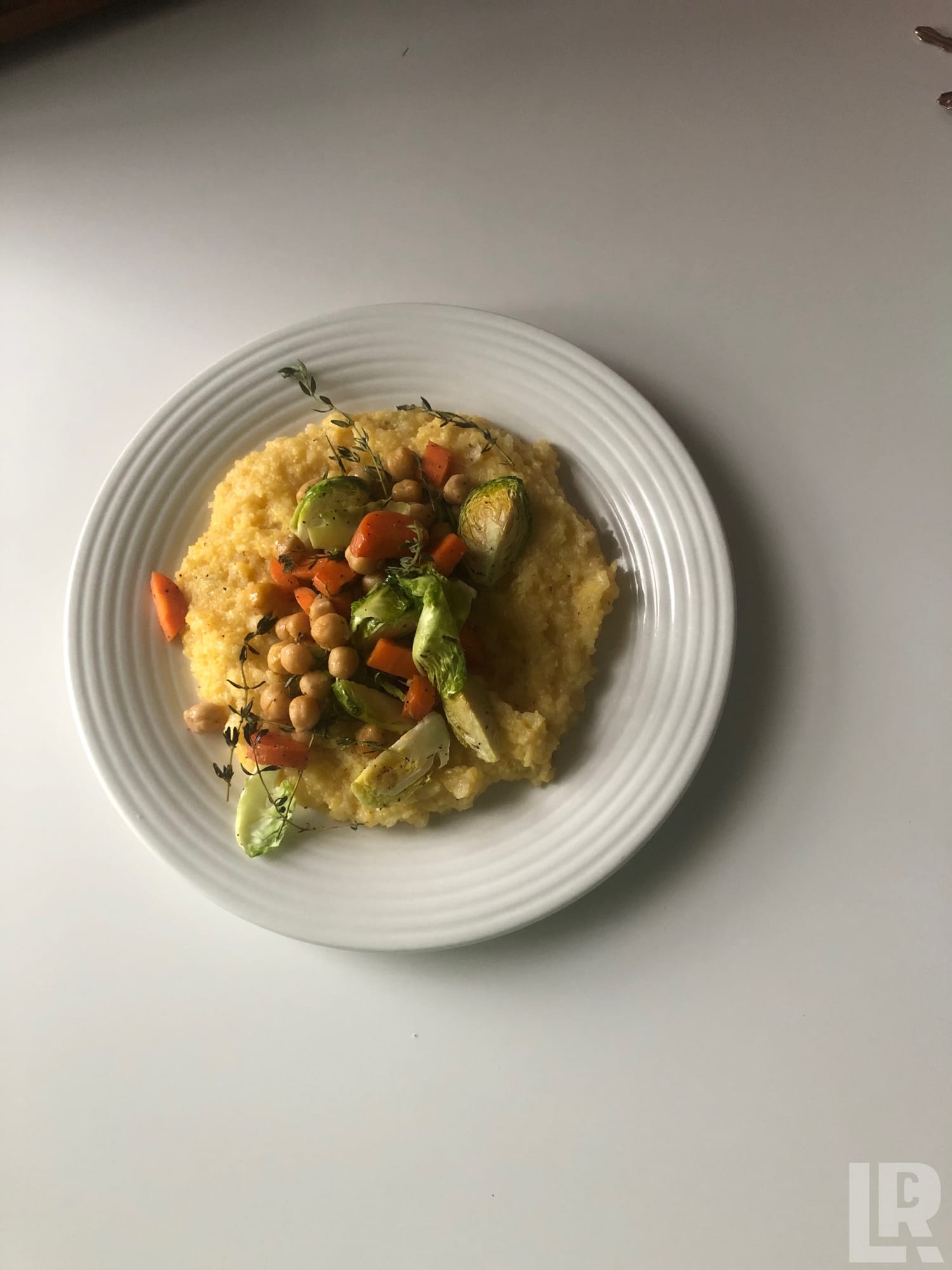 Plate of polenta with roasted vegetables and chickpeas