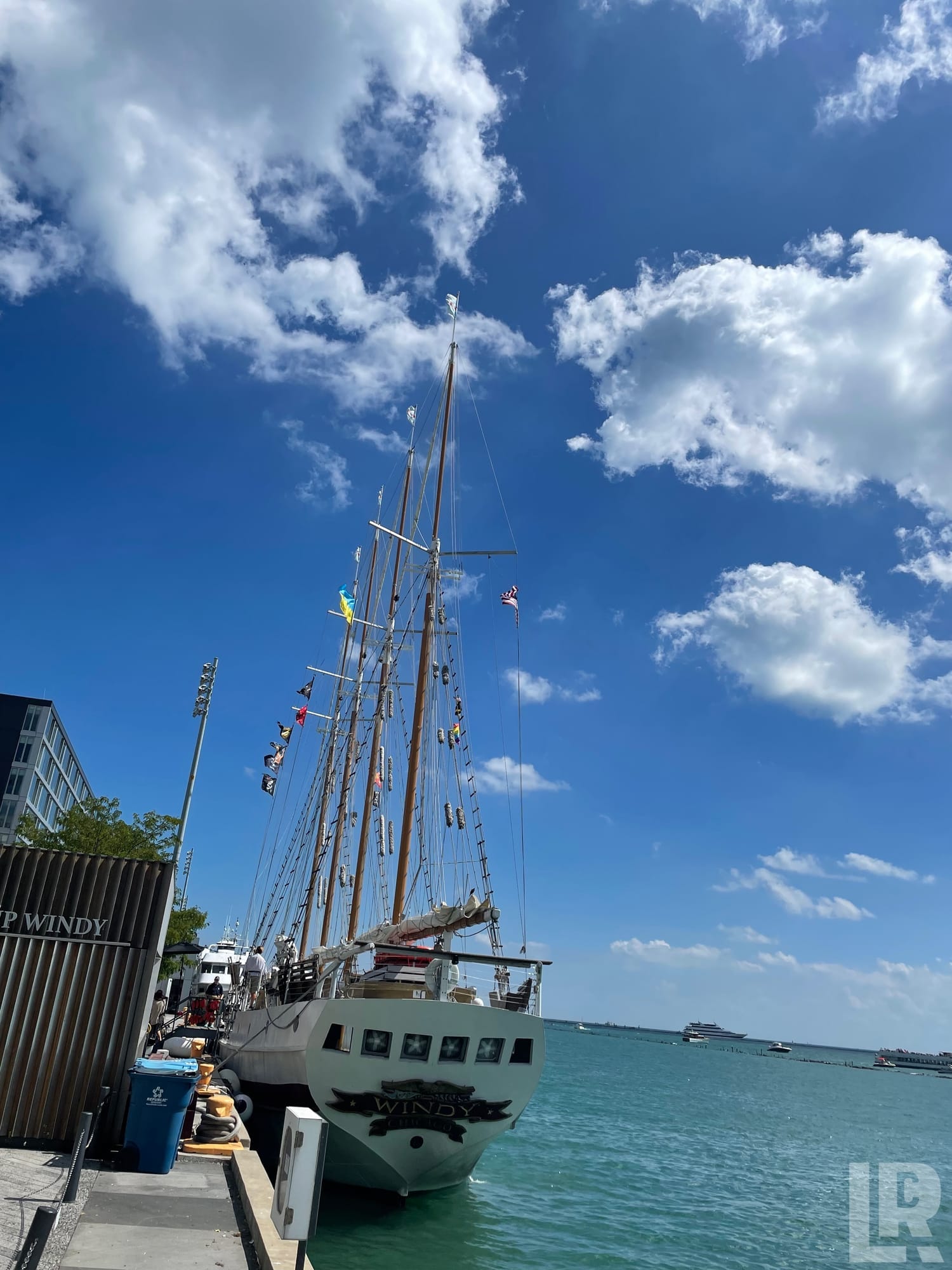 Tall ship named Windy moored at a dock on calm turquoise water