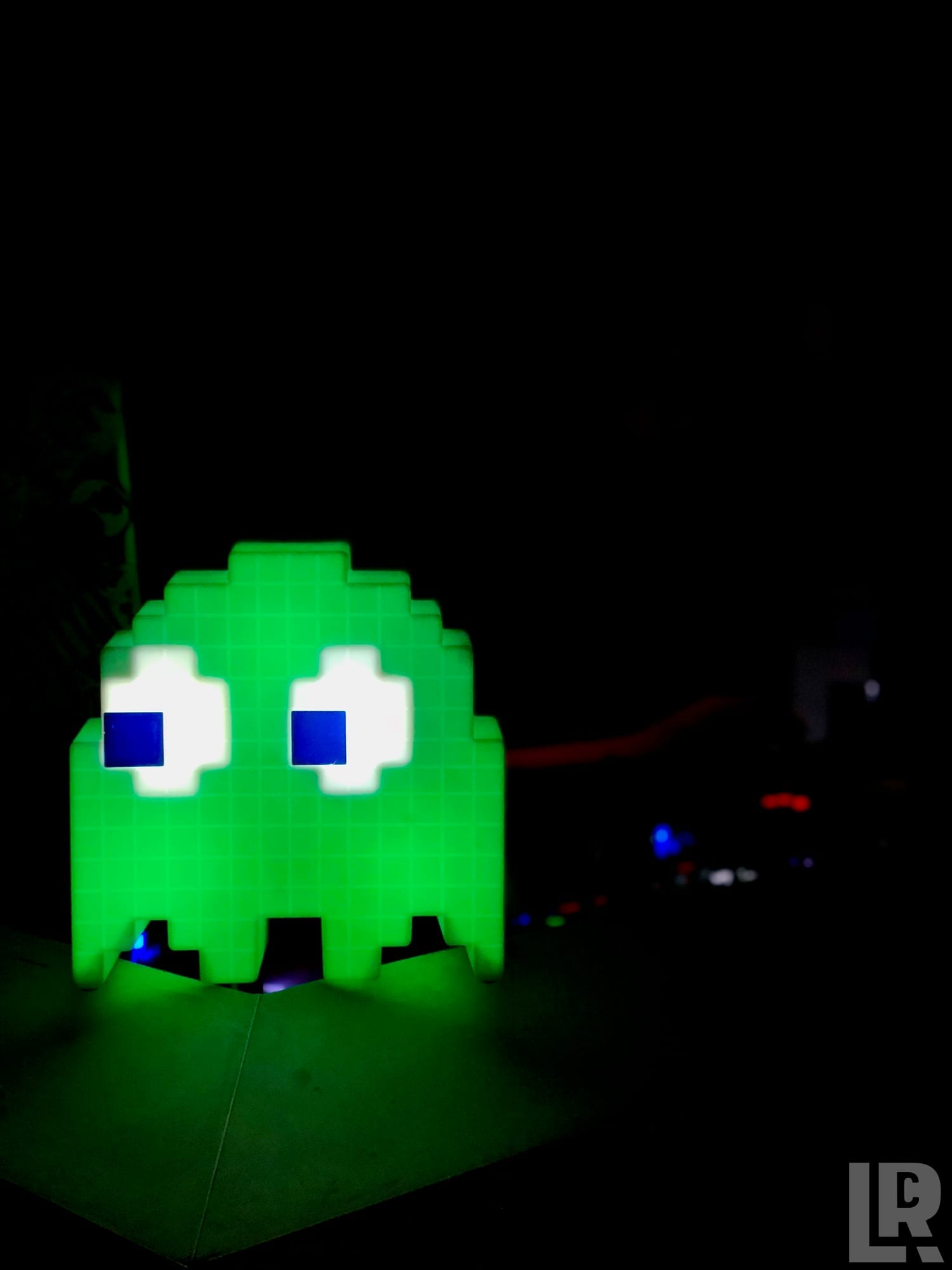 Green pixel-art Pac-Man ghost night light glowing in the dark
